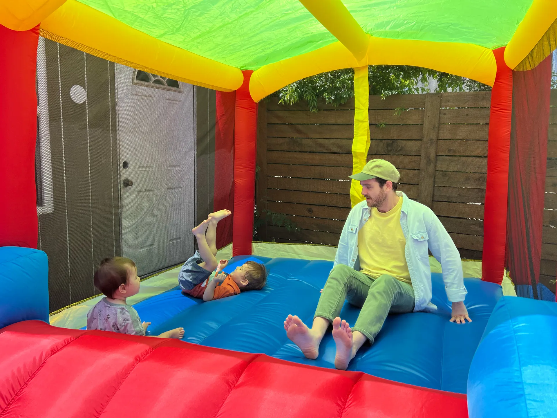 Alex and his nephews in a bounce house